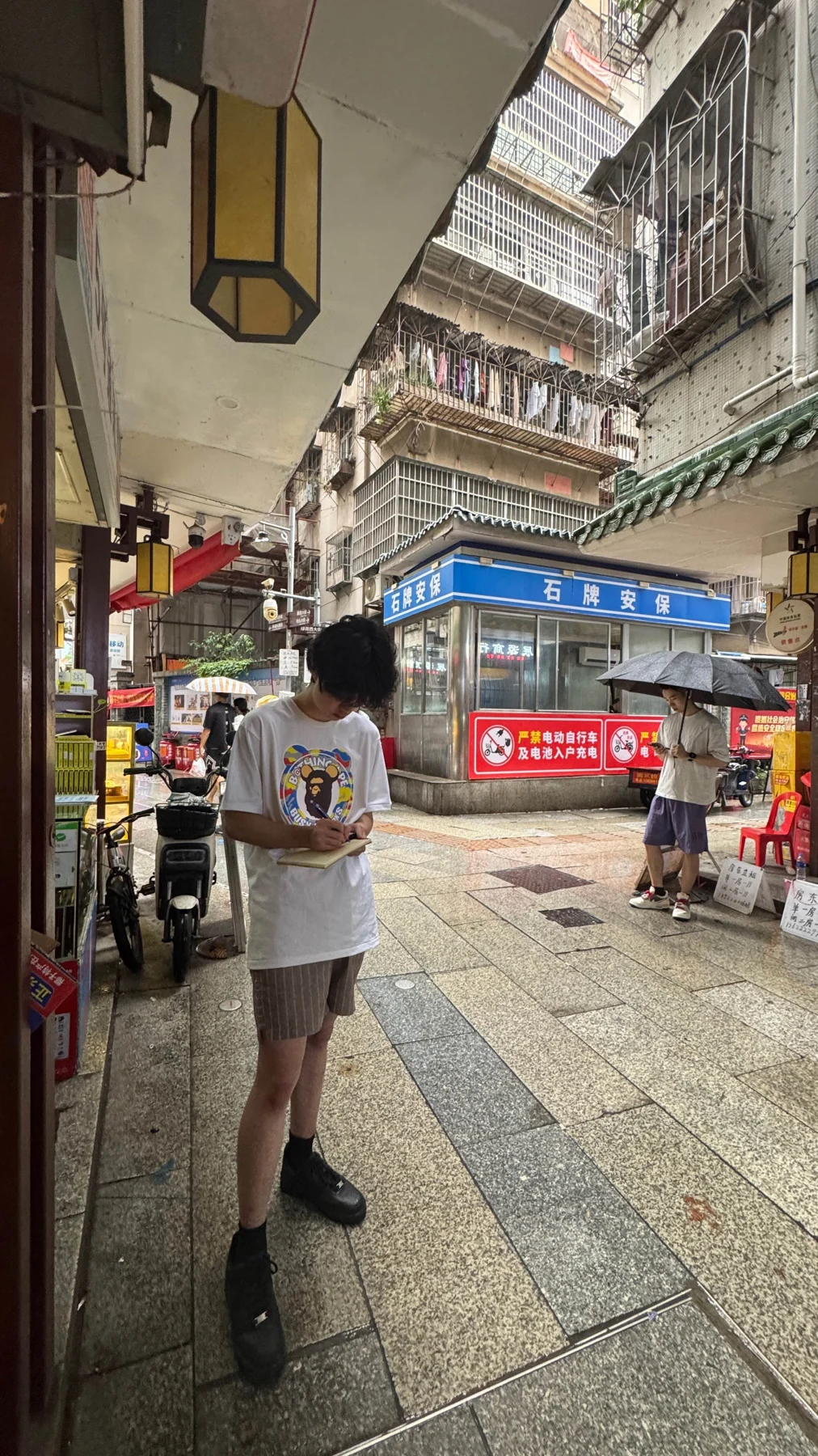 Silas conducting fieldwork on a street in an urban village