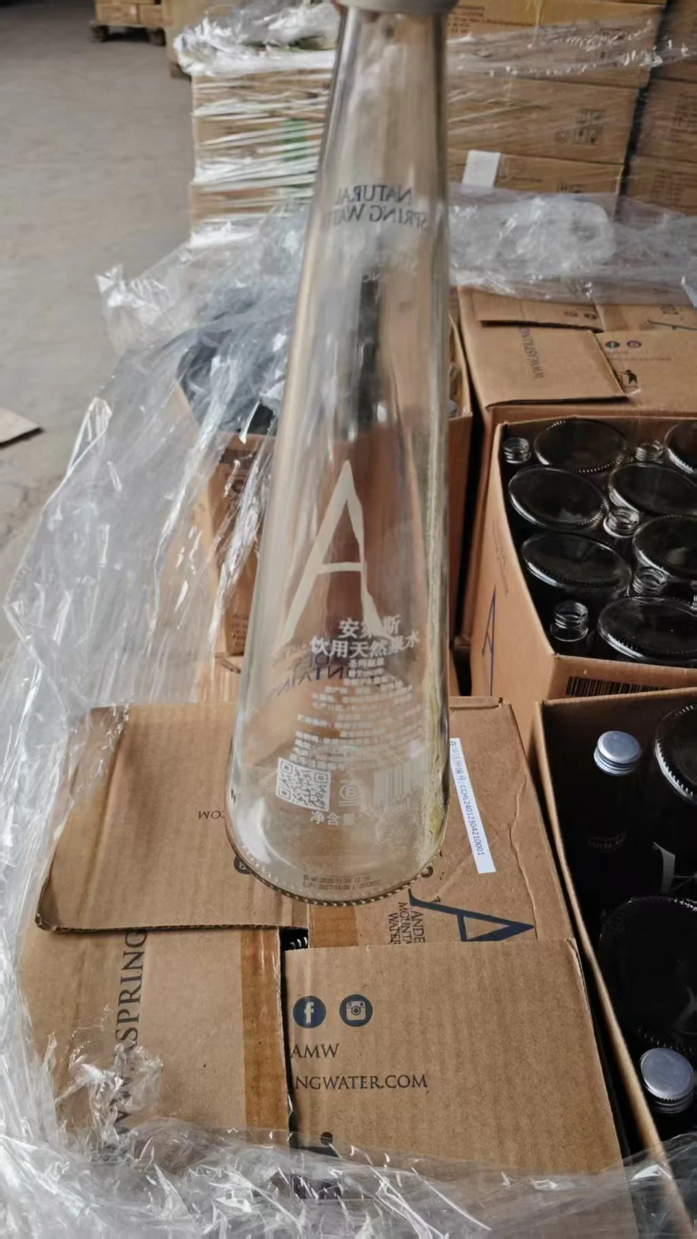 Clear collected glass bottle held for inspection