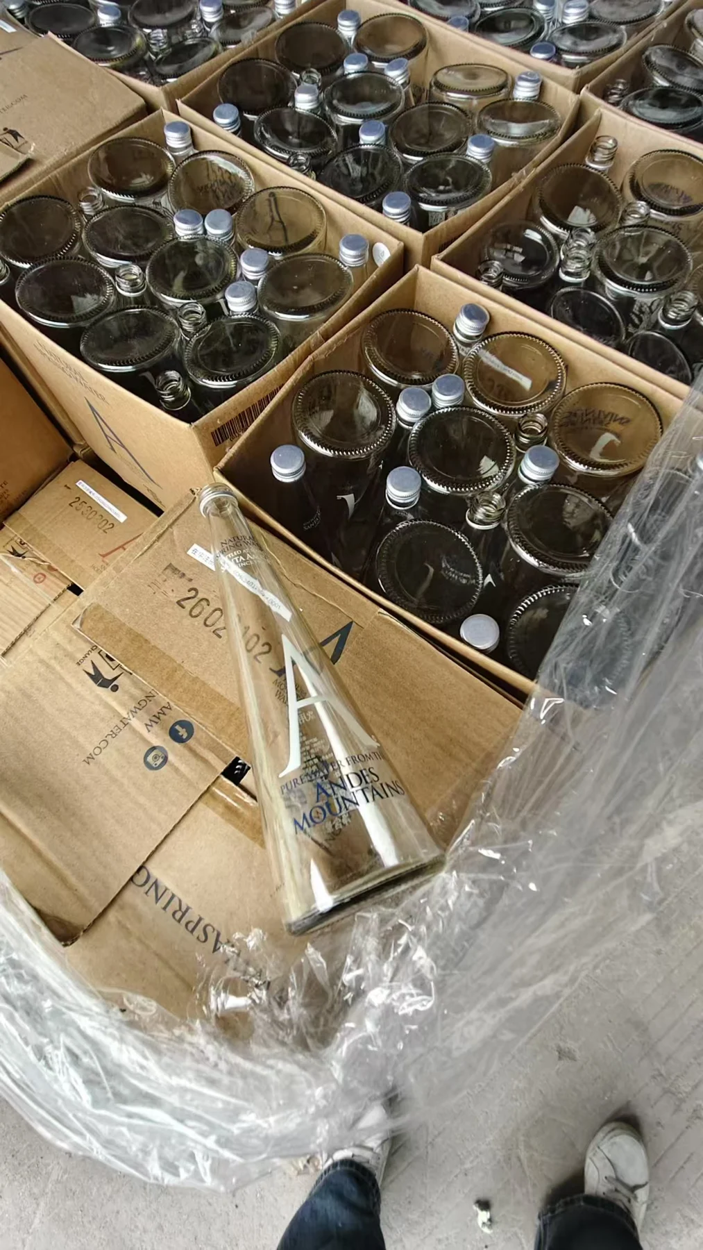 Used glass bottles collected in cardboard cartons