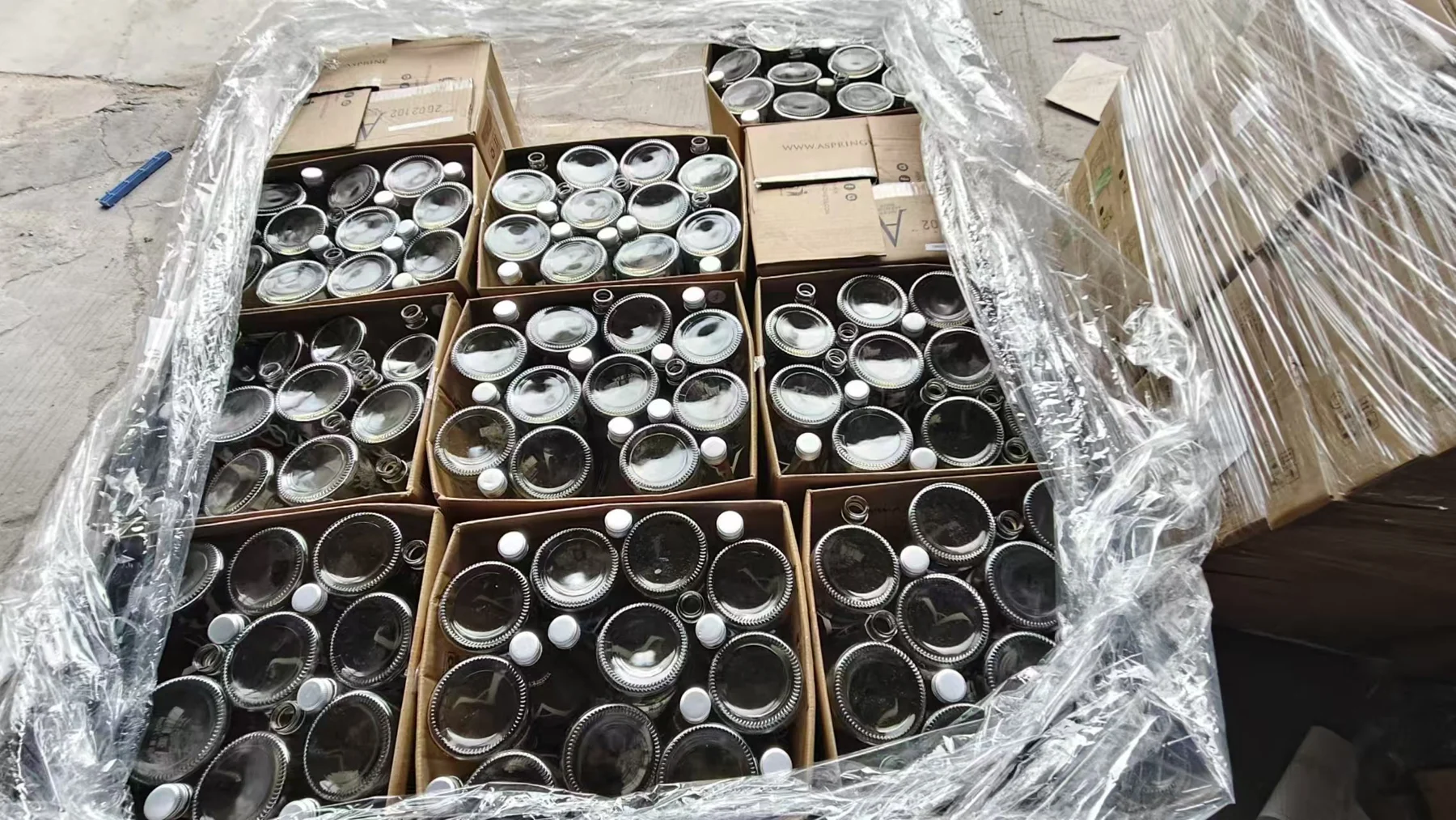 Collected glass bottles in cartons at the factory