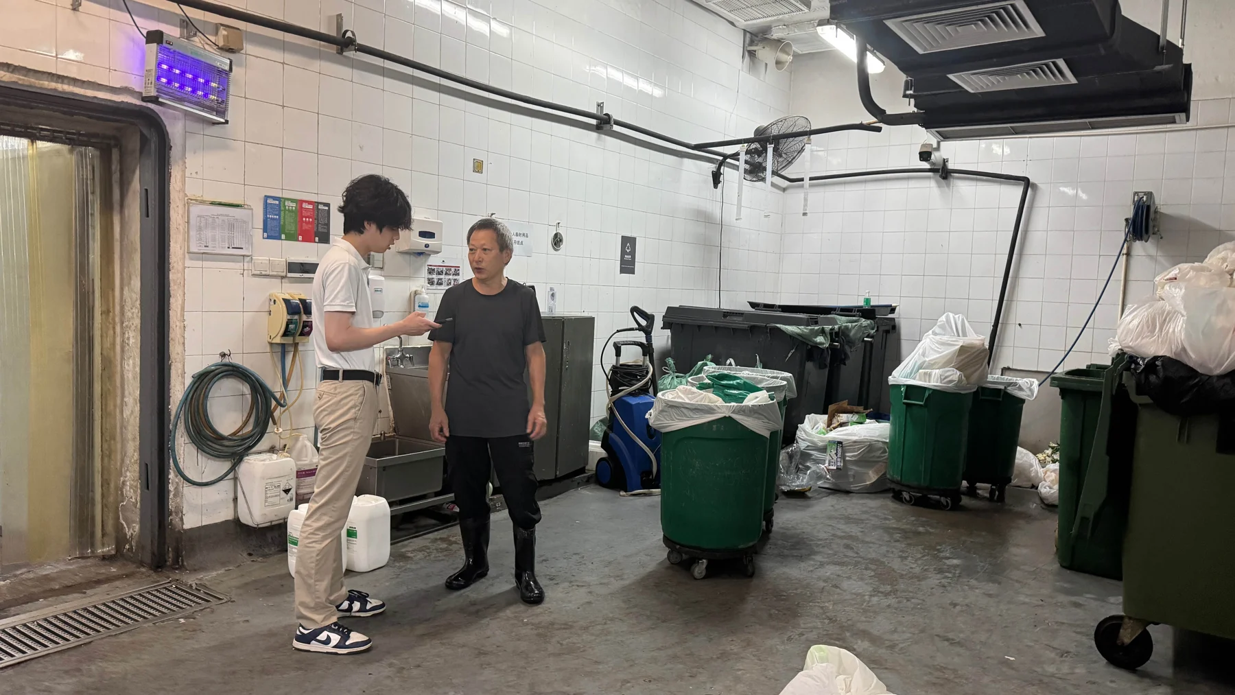 Silas speaking with a worker in a Mandarin Oriental collection area